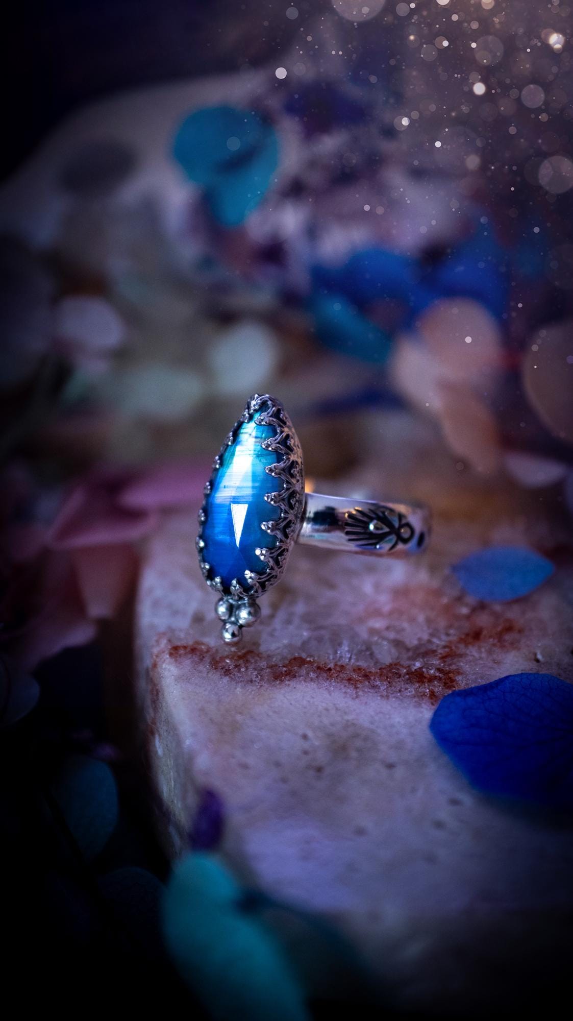 Beautiful and completely handmade, rainbow moonstone, gothic style mini statement stacker ring. This ring has been handcrafted using a mix of fine and sterling silver. Featuring a beautiful, high grade rainbow moonstone. The crystal is rose cut for a sparkle and is full of blue flash! Around the moonstone is a gothic gallery wire bezel, and little silver ball accents. The ring shank has a one of a kind stamped pattern. Ideal for birthdays and special occasions. Gothic and witchy jewellery.