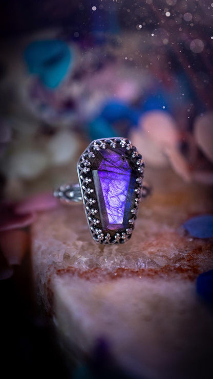 Beautiful and completely handmade, purple labradorite coffin, gothic style, mini statement stacker ring. This ring has been handcrafted using a mix of fine and sterling silver. Featuring a beautiful, purple labradorite gemstone. The crystal is step cut for a sparkle and is full of flash! Around the labradorite is a gothic gallery wire bezel for extra gothic vibes. The ring shank has a one of a kind stamped pattern. Ideal for birthdays and special occasions. Gothic and witchy jewellery.