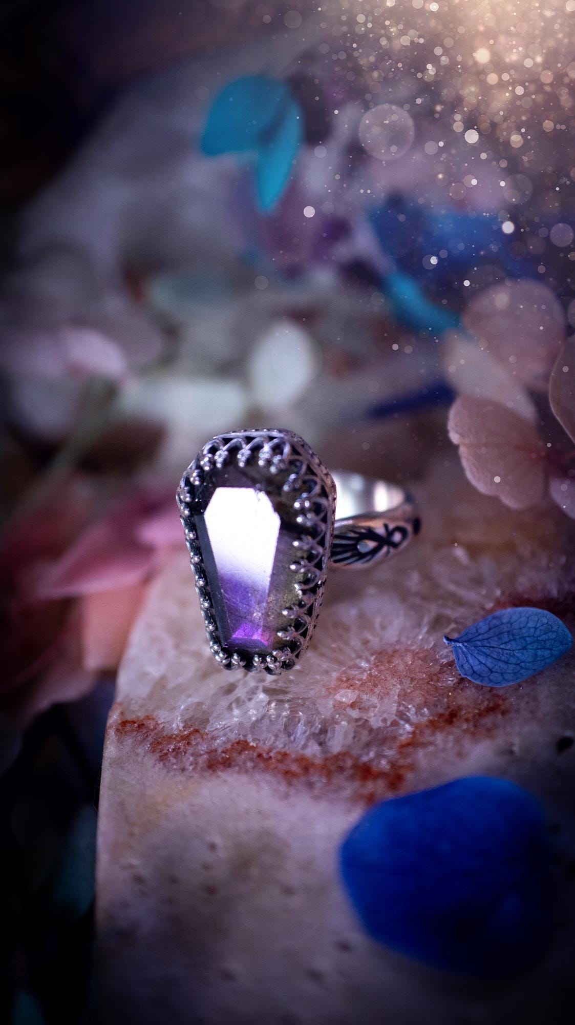 Beautiful and completely handmade, purple labradorite coffin, gothic style, mini statement stacker ring. This ring has been handcrafted using a mix of fine and sterling silver. Featuring a beautiful, purple labradorite gemstone. The crystal is step cut for a sparkle and is full of flash! Around the labradorite is a gothic gallery wire bezel for extra gothic vibes. The ring shank has a one of a kind stamped pattern. Ideal for birthdays and special occasions. Gothic and witchy jewellery.