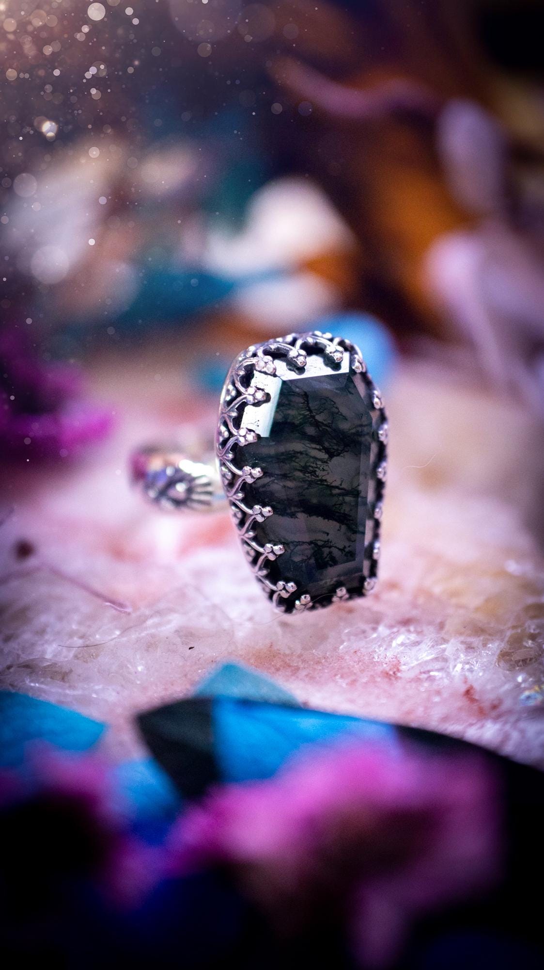 Beautiful and completely handmade, moss agate coffin, gothic style, mini statement stacker ring. This ring has been handcrafted using a mix of fine and sterling silver. Featuring a beautiful, very mossy, moss agate gemstone. The crystal is step cut for a sparkle and is full of flash! Around the moss agate is a gothic gallery wire bezel for extra gothic vibes. The ring shank has a one of a kind stamped pattern. Ideal for birthdays and special occasions. Gothic and witchy jewellery.