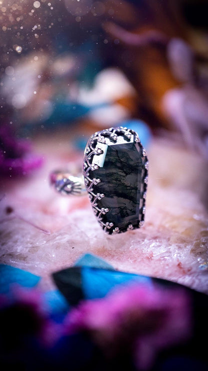 Beautiful and completely handmade, moss agate coffin, gothic style, mini statement stacker ring. This ring has been handcrafted using a mix of fine and sterling silver. Featuring a beautiful, very mossy, moss agate gemstone. The crystal is step cut for a sparkle and is full of flash! Around the moss agate is a gothic gallery wire bezel for extra gothic vibes. The ring shank has a one of a kind stamped pattern. Ideal for birthdays and special occasions. Gothic and witchy jewellery.