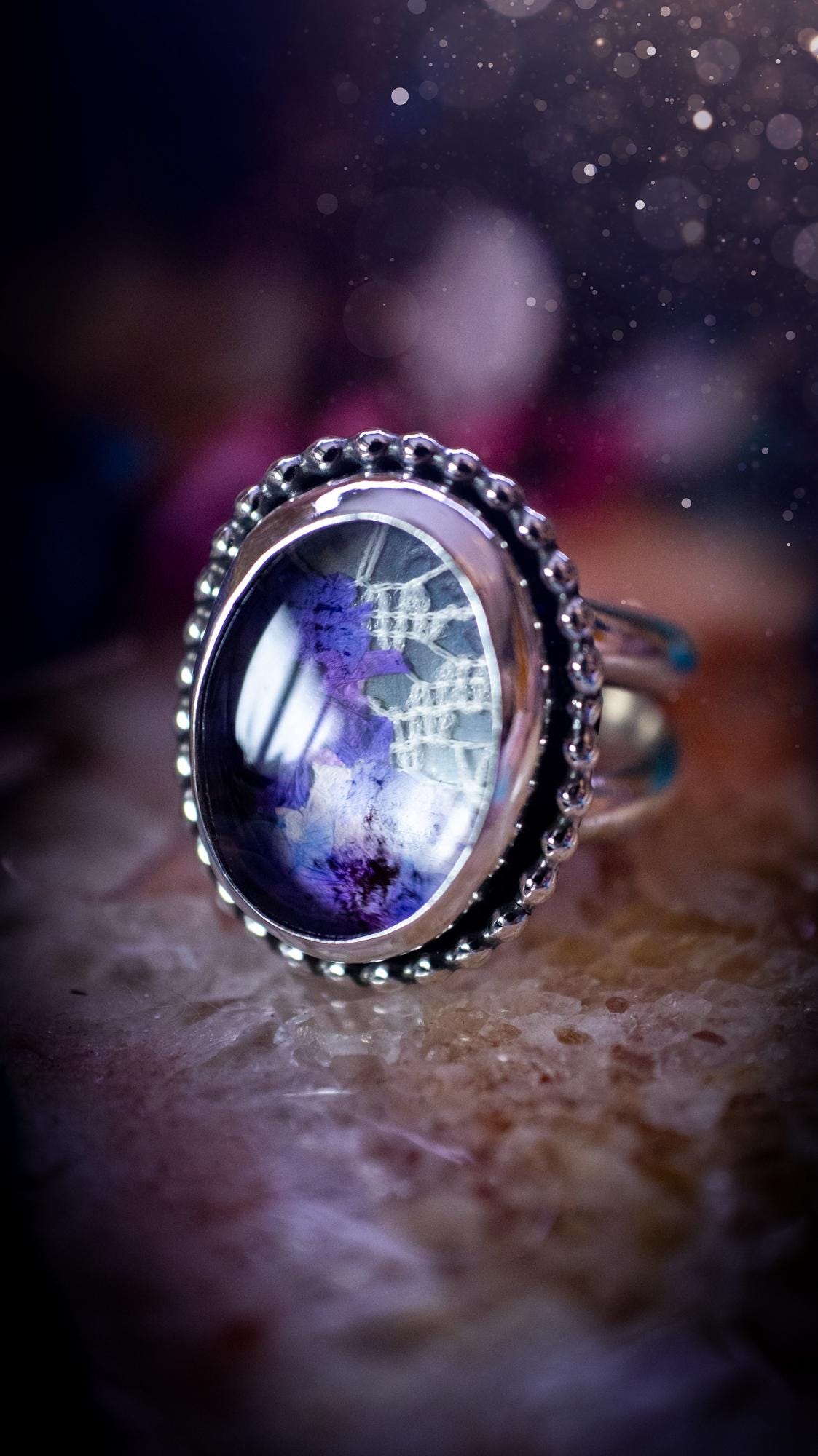 Beautiful and one of a kind, quartz crystal, botanical mini statement ring. This ring has been made by placing lace and real dried flowers under a smooth, quartz crystal. Handmade from fine and sterling silver, featuring a smooth bezel, beaded wire around the bezel and a smooth double ring band. A very unique piece to gift to a loved one who may love crystals and flowers. Ideal for birthdays, anniversaries, and any special occasion. A unique take to sterling silver jewellery.