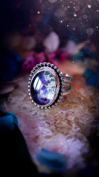 Beautiful and one of a kind, quartz crystal, botanical mini statement ring. This ring has been made by placing lace and real dried flowers under a smooth, quartz crystal. Handmade from fine and sterling silver, featuring a smooth bezel, beaded wire around the bezel and a smooth double ring band. A very unique piece to gift to a loved one who may love crystals and flowers. Ideal for birthdays, anniversaries, and any special occasion. A unique take to sterling silver jewellery.