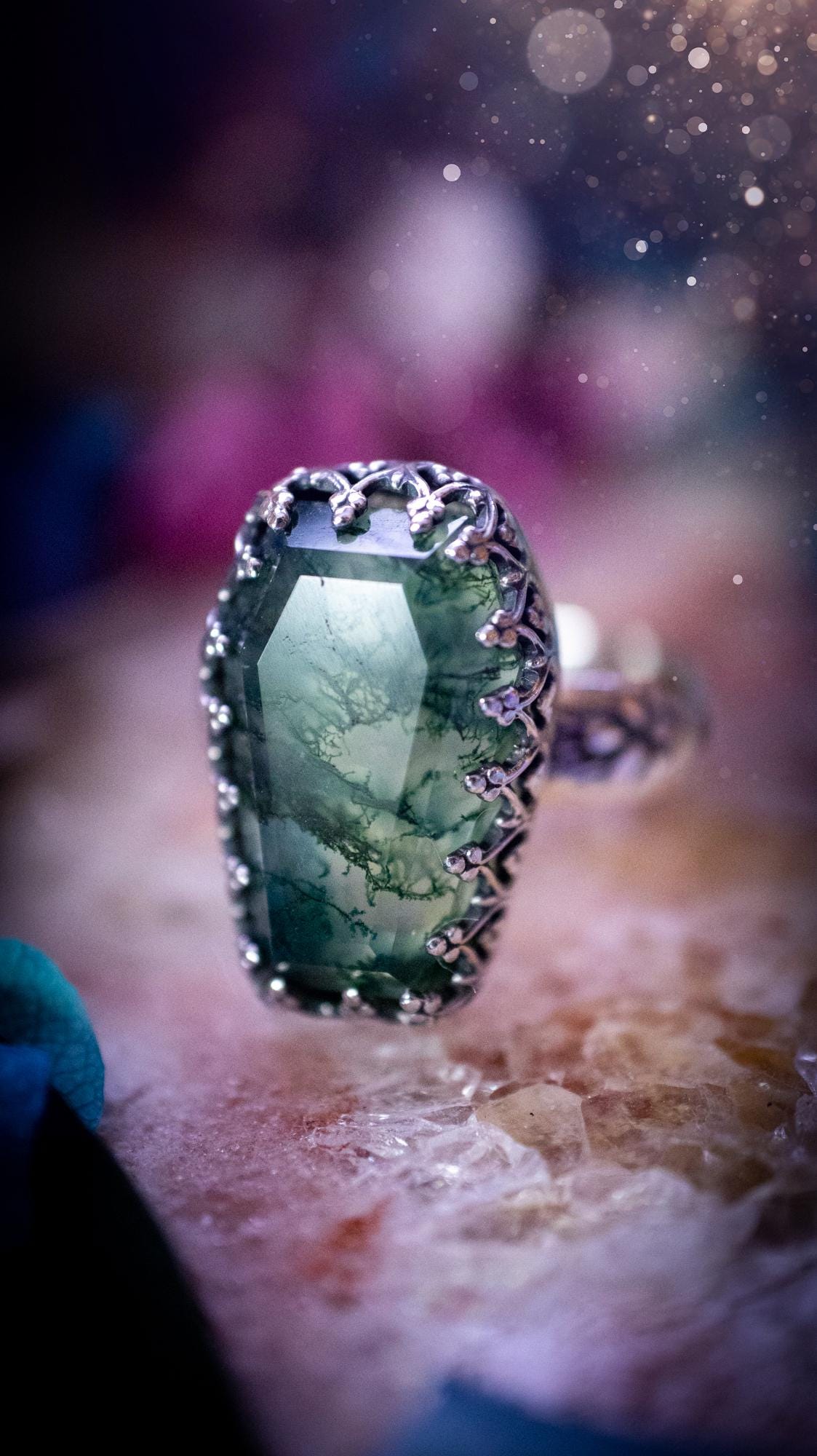 Beautiful and completely handmade, moss agate coffin, gothic style, mini statement stacker ring. This ring has been handcrafted using a mix of fine and sterling silver. Featuring a beautiful, very mossy, moss agate gemstone. The crystal is step cut for a sparkle and is full of flash! Around the moss agate is a gothic gallery wire bezel for extra gothic vibes. The ring shank has a one of a kind stamped pattern. Ideal for birthdays and special occasions. Gothic and witchy jewellery.