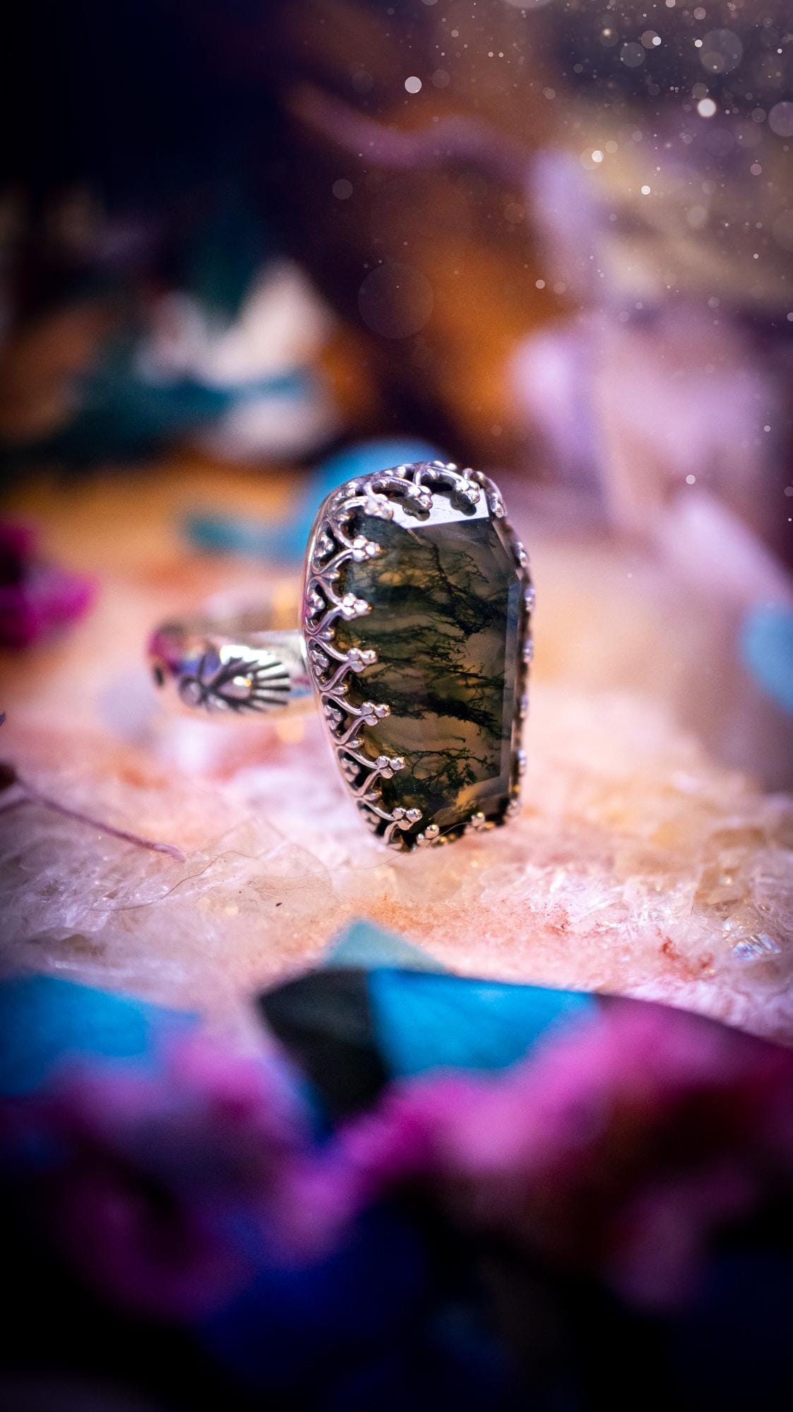 Beautiful and completely handmade, moss agate coffin, gothic style, mini statement stacker ring. This ring has been handcrafted using a mix of fine and sterling silver. Featuring a beautiful, very mossy, moss agate gemstone. The crystal is step cut for a sparkle and is full of flash! Around the moss agate is a gothic gallery wire bezel for extra gothic vibes. The ring shank has a one of a kind stamped pattern. Ideal for birthdays and special occasions. Gothic and witchy jewellery.