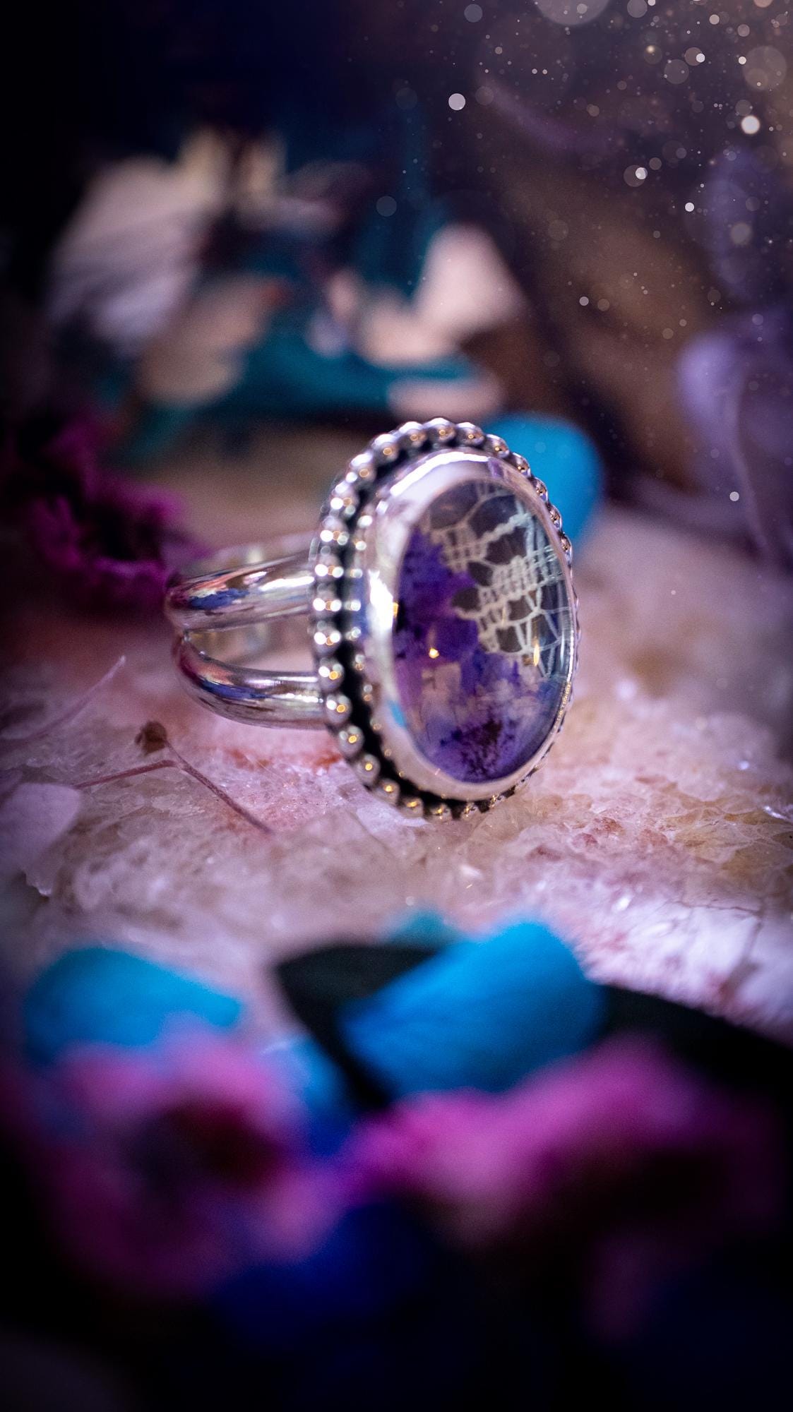 Beautiful and one of a kind, quartz crystal, botanical mini statement ring. This ring has been made by placing lace and real dried flowers under a smooth, quartz crystal. Handmade from fine and sterling silver, featuring a smooth bezel, beaded wire around the bezel and a smooth double ring band. A very unique piece to gift to a loved one who may love crystals and flowers. Ideal for birthdays, anniversaries, and any special occasion. A unique take to sterling silver jewellery.