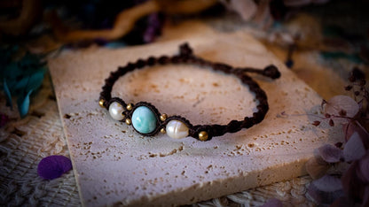 Beautiful and handmade, larimar with fresh water pearls macrame bracelet. This bracelet has been handmade using high quality Linhasita wax cord which is a dark brown colour. Featuring stunning, high quality Larimar crystal beads that are full of natural pattern. There are brass beads within the macrame pattern and fresh water pearls. A lovely little gift for a close one, or a little treat for yourself! Ideal for birthdays, anniversaries, and special occasions. Hippy jewellery for the soul.