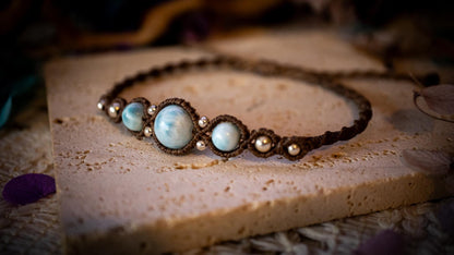 Beautiful and handmade, larimar with sterling silver beads, macrame bracelet. This bracelet has been handmade using high quality Linhasita wax cord which is a dark brown colour. Featuring stunning, high quality Larimar crystal beads that are full of natural pattern. There are also 925 sterling silver beads within the macrame pattern. A lovely little gift for a close one, or a little treat for yourself! Ideal for birthdays, anniversaries, and special occasions. Hippy jewellery for the soul.