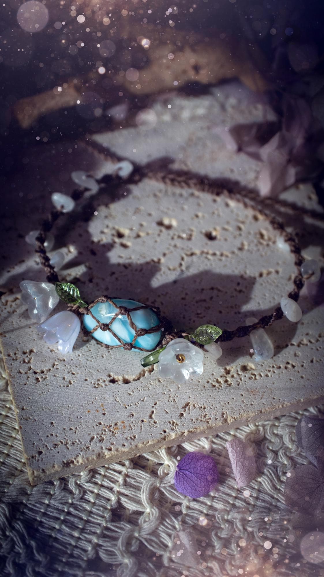 Beautifully handmade, authentic and natural crystal larimar, macrame fairy bracelet. This bracelet has been made using high quality Linhasita waxed cord in cedar brown colour. Featuring a beautiful larimar crystal as the focal point that is surrounded by glass flowers that have 24k plated gold beads, moonstone chip crystals and little cute leaves. The bracelet also has a slider knot for size adjustments. Ideal for anyone who loves a whimsical aesthetic, crystals, florals and hippy jewellery.