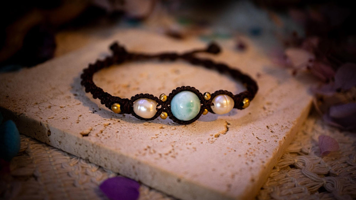 Beautiful and handmade, larimar with fresh water pearls macrame bracelet. This bracelet has been handmade using high quality Linhasita wax cord which is a dark brown colour. Featuring stunning, high quality Larimar crystal beads that are full of natural pattern. There are brass beads within the macrame pattern and fresh water pearls. A lovely little gift for a close one, or a little treat for yourself! Ideal for birthdays, anniversaries, and special occasions. Hippy jewellery for the soul.