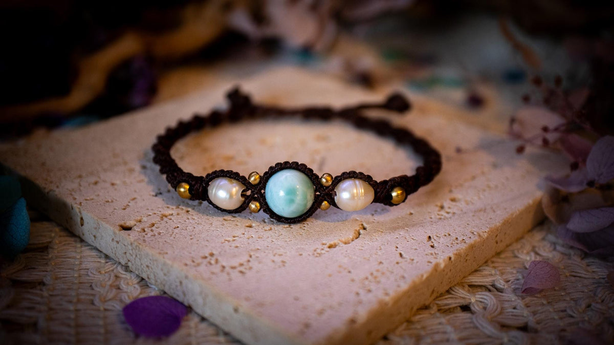 Beautiful and handmade, larimar with fresh water pearls macrame bracelet. This bracelet has been handmade using high quality Linhasita wax cord which is a dark brown colour. Featuring stunning, high quality Larimar crystal beads that are full of natural pattern. There are brass beads within the macrame pattern and fresh water pearls. A lovely little gift for a close one, or a little treat for yourself! Ideal for birthdays, anniversaries, and special occasions. Hippy jewellery for the soul.
