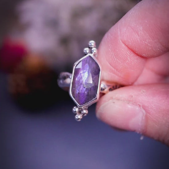 Beautiful, gothic and handmade, purple labradorite crystal statement ring. This ring has been handmade from recycled sterling silver featuring the most beautiful rose cut labradorite that is full of sparkle and purple flash. Mounted on a stamped ring shank. Unique jewellery gifts.