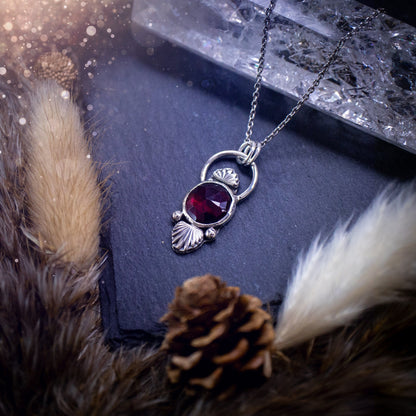 Beautiful, rose cut garnet sterling silver pendant. This little pendant has been handmade with love and care and has the most stunning pinks and reds within the gemstone. Accompanied by silver components including a free chain. Ideal crystal gift.