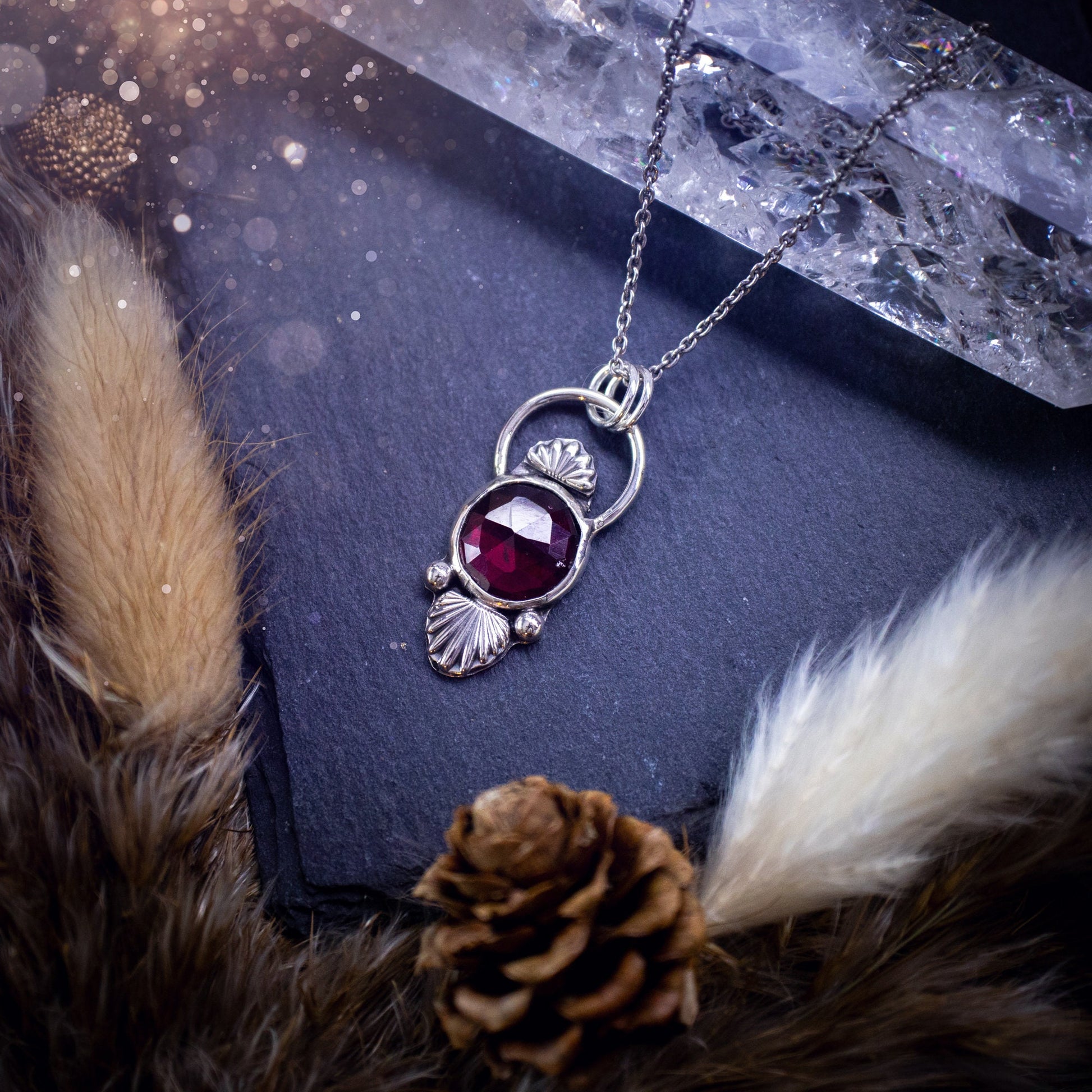 Beautiful, rose cut garnet sterling silver pendant. This little pendant has been handmade with love and care and has the most stunning pinks and reds within the gemstone. Accompanied by silver components including a free chain. Ideal crystal gift.