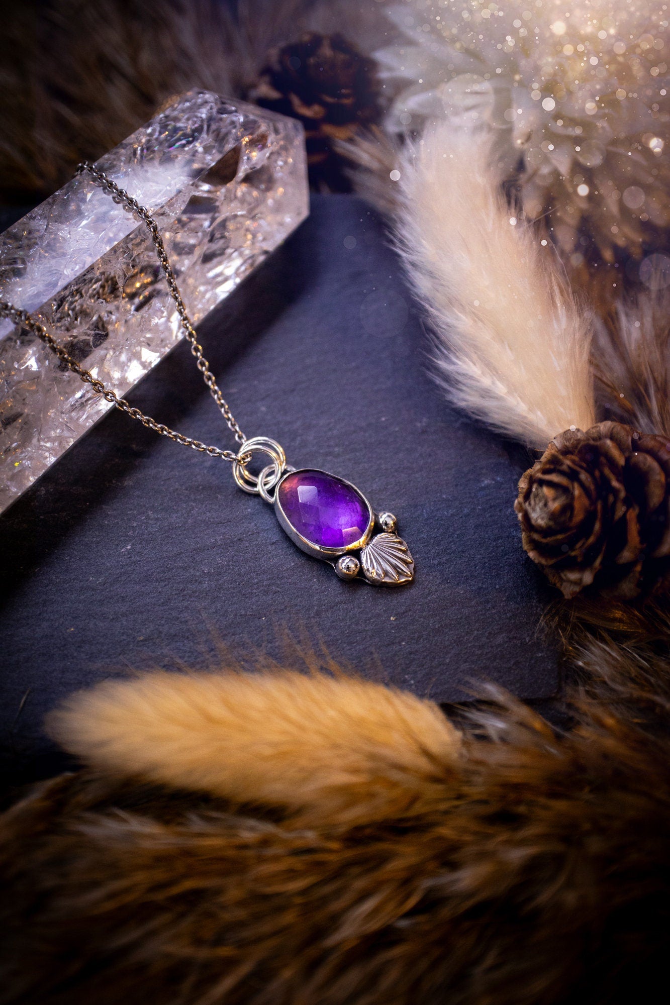 Beautiful, rose cut Amethyst sterling silver pendant. This little pendant has been handmade with love and care and has the most stunning purples within the gemstone. Accompanied by silver components including a free chain. Ideal crystal gift.