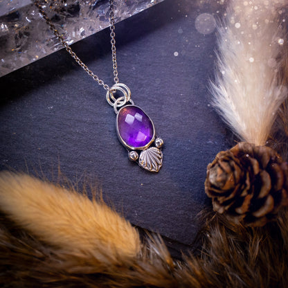 Beautiful, rose cut Amethyst sterling silver pendant. This little pendant has been handmade with love and care and has the most stunning purples within the gemstone. Accompanied by silver components including a free chain. Ideal crystal gift.