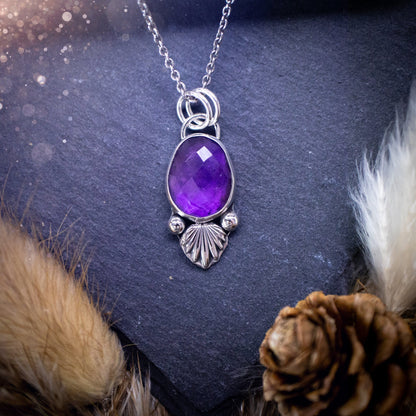 Beautiful, rose cut Amethyst sterling silver pendant. This little pendant has been handmade with love and care and has the most stunning purples within the gemstone. Accompanied by silver components including a free chain. Ideal crystal gift.4