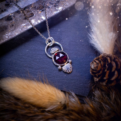 Beautiful, rose cut garnet sterling silver pendant. This little pendant has been handmade with love and care and has the most stunning pinks and reds within the gemstone. Accompanied by silver components including a free chain. Ideal crystal gift.