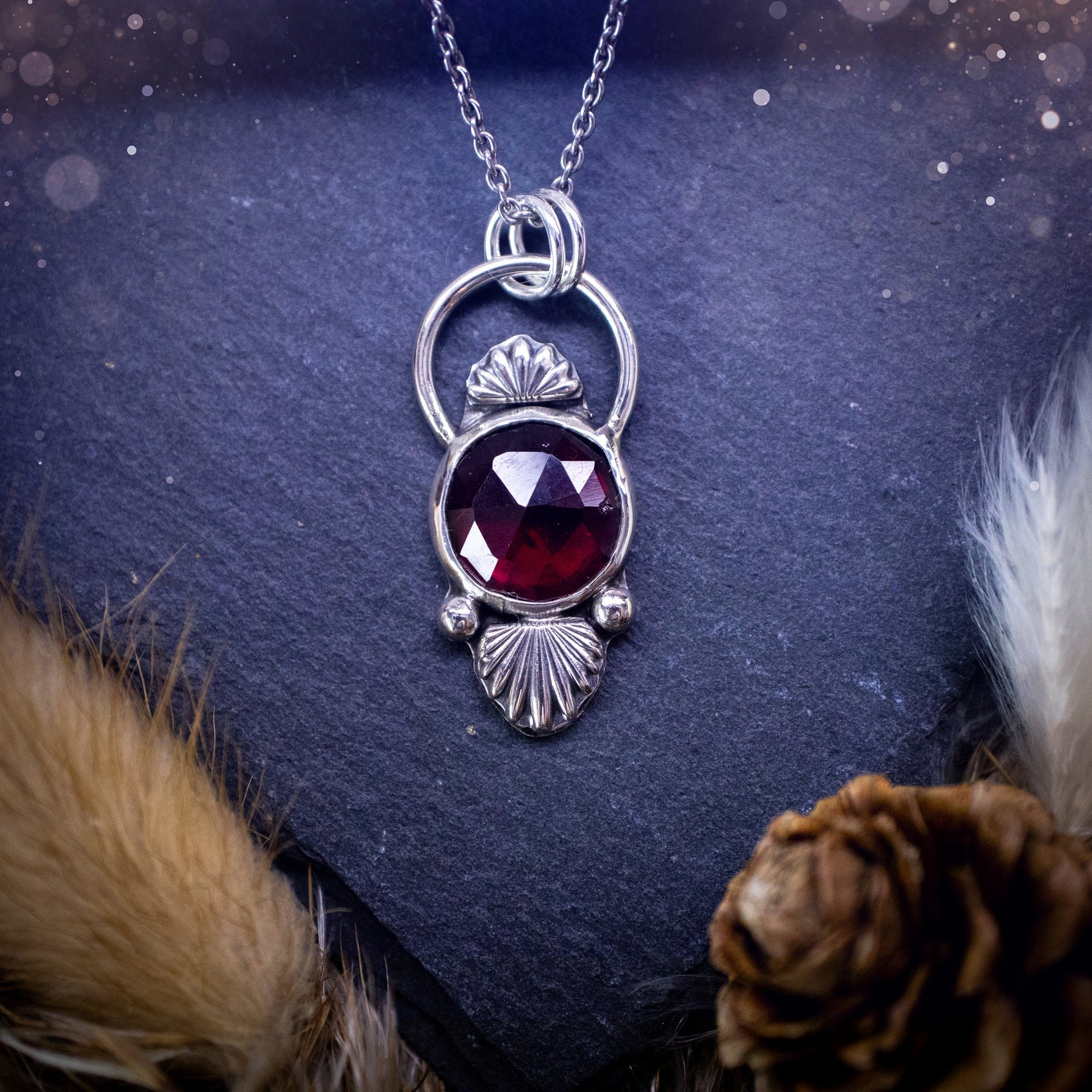 Beautiful, rose cut garnet sterling silver pendant. This little pendant has been handmade with love and care and has the most stunning pinks and reds within the gemstone. Accompanied by silver components including a free chain. Ideal crystal gift.