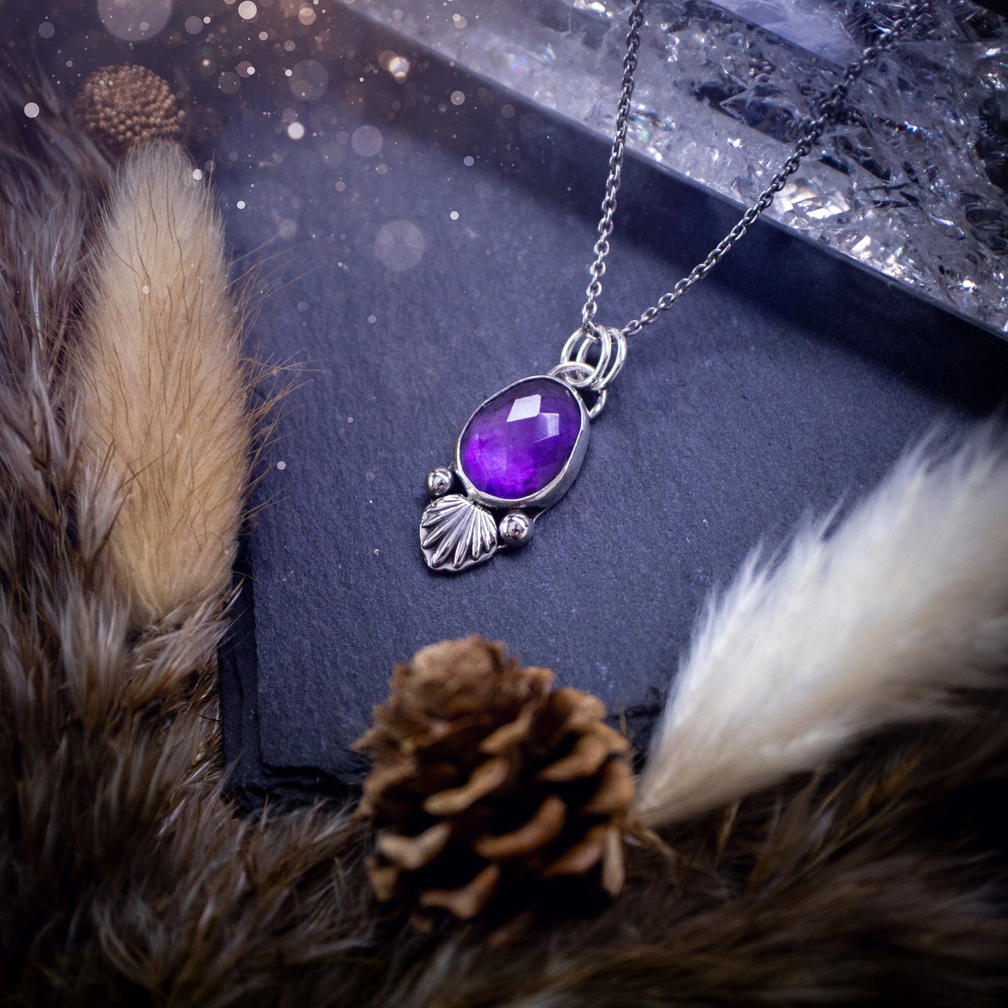 Beautiful, rose cut Amethyst sterling silver pendant. This little pendant has been handmade with love and care and has the most stunning purples within the gemstone. Accompanied by silver components including a free chain. Ideal crystal gift.