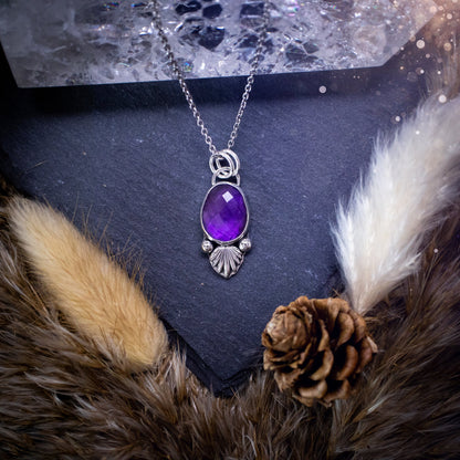 Beautiful, rose cut Amethyst sterling silver pendant. This little pendant has been handmade with love and care and has the most stunning purples within the gemstone. Accompanied by silver components including a free chain. Ideal crystal gift.