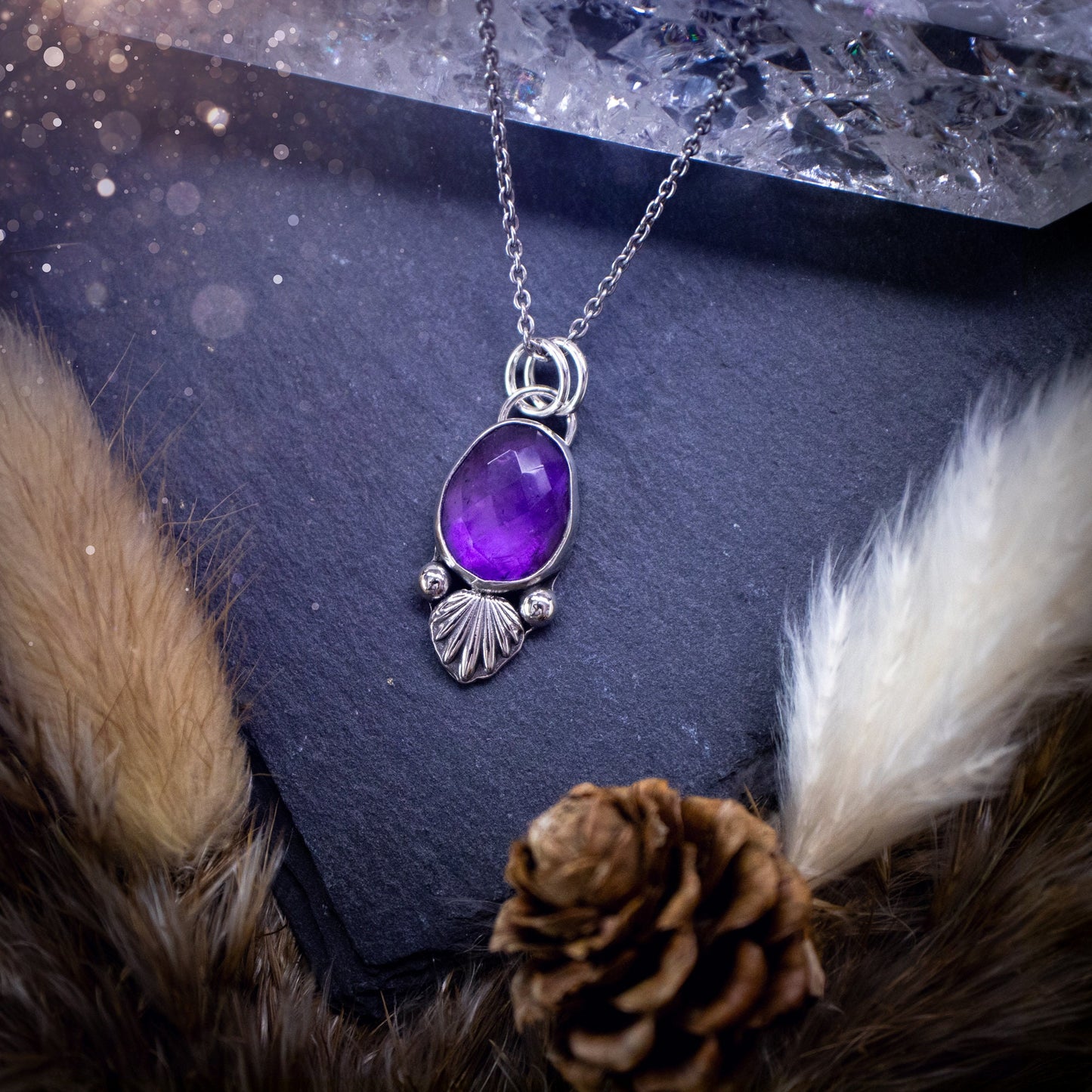 Beautiful, rose cut Amethyst sterling silver pendant. This little pendant has been handmade with love and care and has the most stunning purples within the gemstone. Accompanied by silver components including a free chain. Ideal crystal gift.