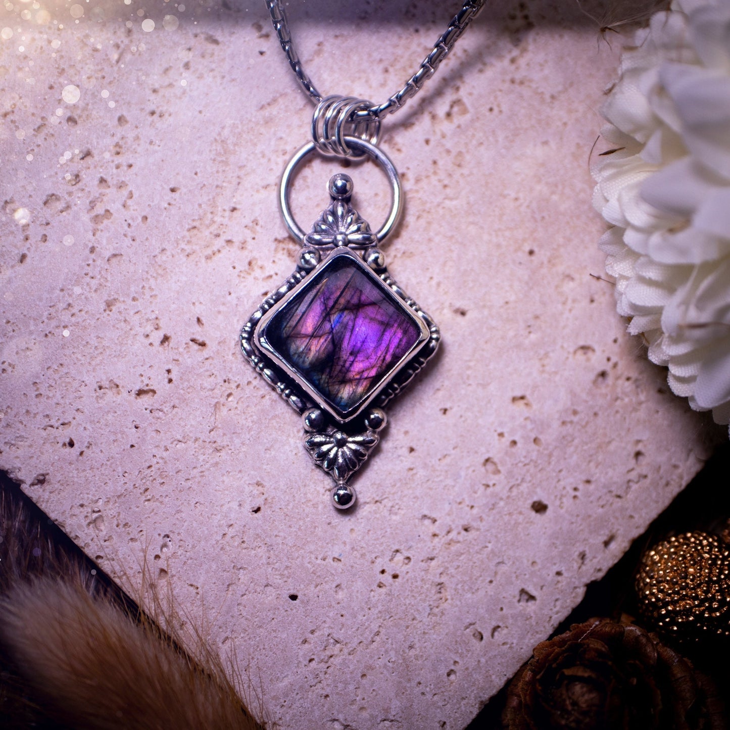 Beautiful and handmade, natural purple and pink labradorite, crystal pendant necklace. This necklace has been made from fine and sterling silver and features silver fan components. The ideal gift for crystal lovers. Hippy, gothic, and witchy.